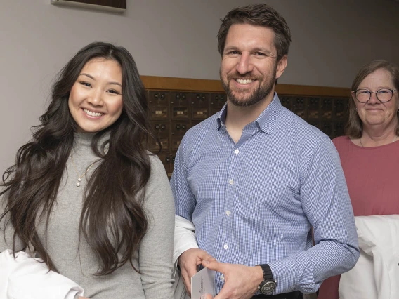 Julie Tran-Commisso, John Tredici and Victoria Kretche-Kitchel prepare for the College of Nursing’s DNP white coat ceremony.