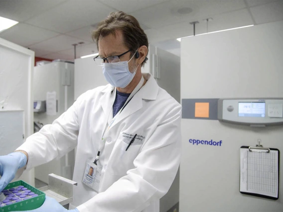 Michael Badowski, PhD, pulls out a vial containing the Pfizer vaccine that will be used at the University POD.