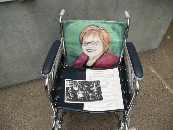 Judy Heumann (1947) — Judy Heumann is a disability advocate who served in both the Clinton and Obama administrations in support of disability rights. She is a co-founder of the World Institute on Disability, one of the first global disability rights organizations founded and led by people with disabilities. Heumann is an internationally recognized leader in the disability rights community. (Acrylics on vinyl with paper, by Suzanne Whitaker)