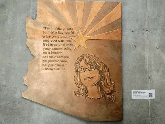 Gabrielle Giffords (1970) — Gabrielle Giffords served in the Arizona House of Representatives and the Arizona Senate prior to being elected to the U.S. House of Representatives in 2007. She survived being shot in the head in an assassination attempt in Tucson that killed six people and injured 13. She and her husband, former space shuttle astronaut and current U.S. Senator, Mark Kelly, founded Giffords, an organization dedicated to gun control legislation.  (Plaster and metallic paint on metal, by Suzanne W