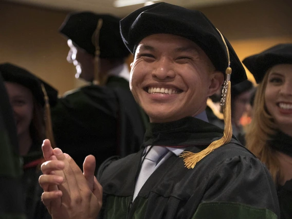 Allen Doan, MD, applauds a speaker during the College of Medicine – Phoenix class of 2022 commencement ceremony.