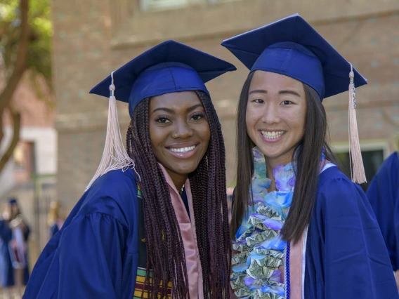 (From left) Jazmin Youngblood and Kara Yagade celebrate the completion of their undergraduate studies at the 2022 Mel and Enid Zuckerman College of Public Health spring convocation.