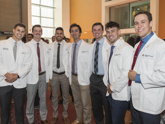 (From left) Class of 2026 students Michael Ruta, Wyatt Koolmees, Michael Mazarei, Tony Gaidici, Jackson Woodrow, Trevin Reyes and Santiago Robledo Logan-Baca pose for a photo in the lobby of Symphony Hall in downtown Phoenix after the white coat ceremony.