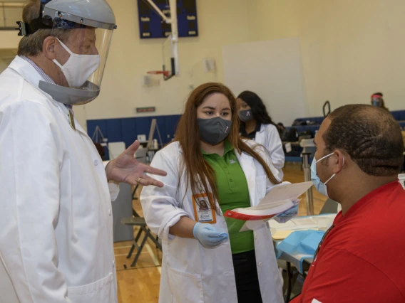 UArizona student Justin Clark learns about the flu vaccination with preceptor Michael Katz, PharmD, professor of pharmacy practice and science, and PharmD student Sammy Zimmerman.