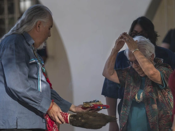 Carlos Gonzales, MD, performs a smudging ceremony, where he blesses each person with the smoke of the sacred cleansing and blessing herbs, which is burned in an abalone shell.