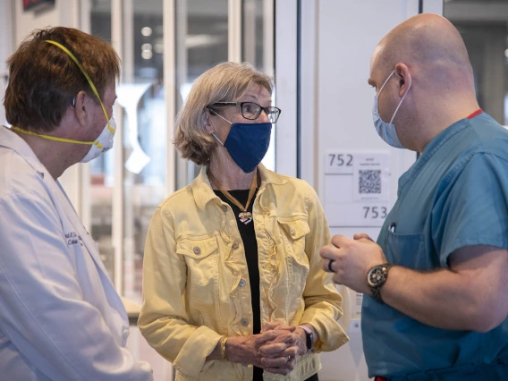 Joe DeBoe, DNP, ACMPC-AG, CCRN, right, talks with  Dean Ida Moore, PhD, RN, FAAN, and David Trinidad, DNP, during the first in-person AGACNP clinical skills intensive to be held at ASTEC since the pandemic. 