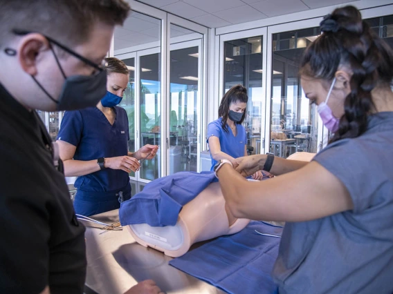 Jaron Allen Hubele, left, and Katie Pon Rambo practice thoracentesis – a procedure where a needle is inserted through the chest wall to remove fluid or air from around the lungs.  