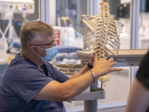 Chris Herring, DNP, CRNA, demonstrates techniques used for a lumbar puncture...  “While CRNA's do not routinely perform this technique for diagnostic reasons, the approach is very similar to the placement of neuraxial blocks which we use for analgesia,” said Dr. Herring.