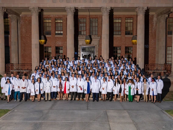 UArizona College of Medicine – Tucson Class of 2025 faculty and staff gather for a group photo in front of Cochise Hall after the white coat ceremony.