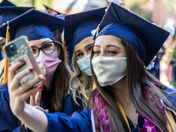 (From left) Nicole Cook, Maia Cochran and Shannon Cloughley pose for a selfie before the start of the College of Nursing fall convocation at Centennial Hall.