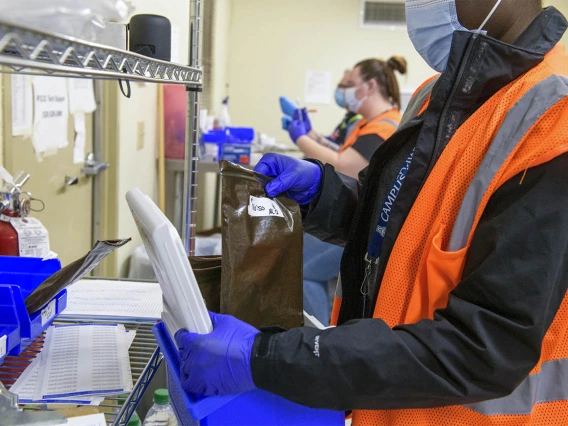 UArizona Campus Health Pharmacy Technician Pearl Craig (right) gathers vaccines that are ready to be distributed to people at the scheduled walk-in location at the Ina E. Gittings Building.