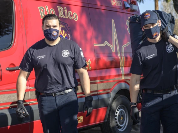 Rico Rio emergency medical technicians approach an accident scene. 