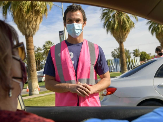 Aaron Yoder checks in with a vaccine recipient, giving instructions to wait for 15 minutes to make sure there are no side effects.