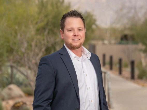 Portrait of Noel Warfel standing outside the University of Arizona Cancer Center