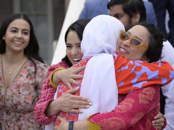 Three smiling women hug at the University of Arizona College of Medicine – Tucson Match Day celebration.