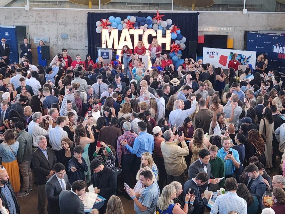 A large crowd of people watch perfomers on a stage at the University of Arizona College of Medicine – Phoenix Match Day celebration. 