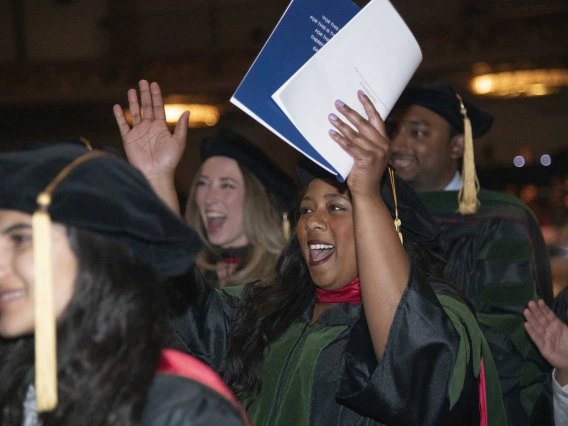 Several University of Arizona College of Medicine – Phoenix students cheer as university President Robert C. Robbins confers their degrees. 