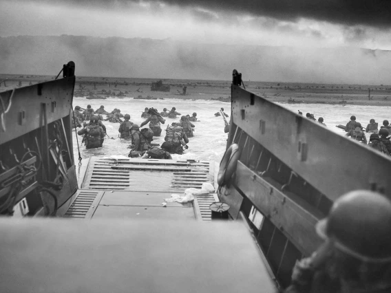 American troops wade ashore from a landing vehicle on Omaha Beach during the D-Day invasion on June 6, 1944.