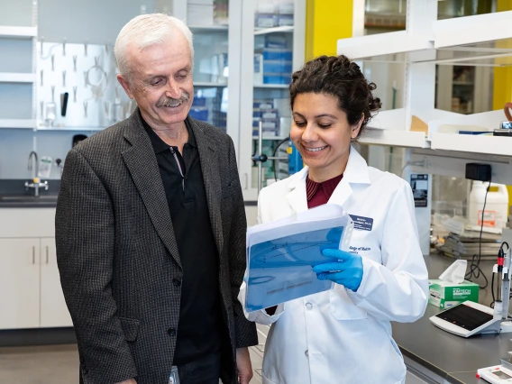 two researchers looking at a paper standing in a research laboratory at the College of Medicine – Phoenix