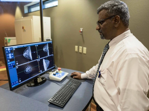 A man views CT images of breasts looking for signs of cancer