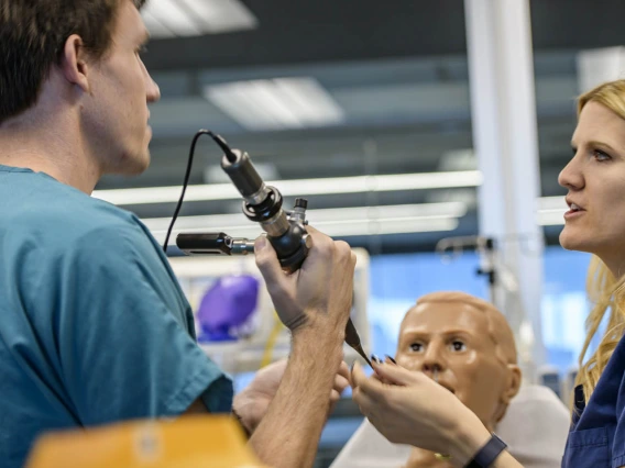 An internal medicine student practices on a simulated airway.