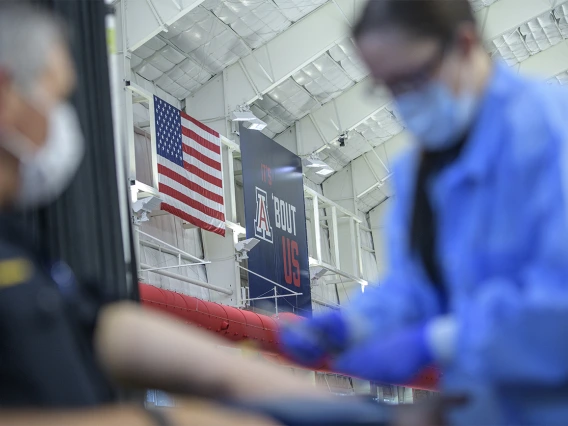 A health care worker prepares to apply a bandage to a police officer who has completed a blood draw for antibody testing April 30.