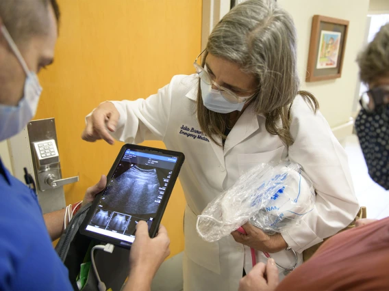 Cristian Laguillo, MD, Copper Queen Community Hospital inpatient medicine director, discusses the bedside ultrasound machine with Julia Brown, MD, and Glenda Trevino, RN, nursing education director. As a family medicine doctor, Dr. Laguillo was excited about the potential of this technology in non-emergency settings.