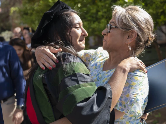 Naiby Rodriguez Zuniga, MD, hugs her mother after the College of Medicine – Tucson class of 2022 convocation at Centennial Hall.