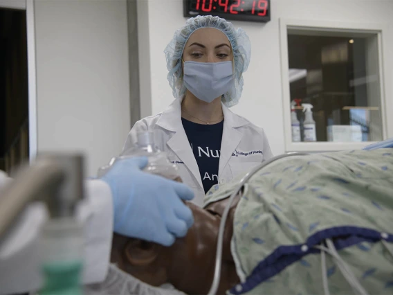 Anastasia Connelly, RN, a second-year CRNA resident, plays the role of an OR nurse during a critical skills simulation at the Arizona Simulation Technology and Education Center. 