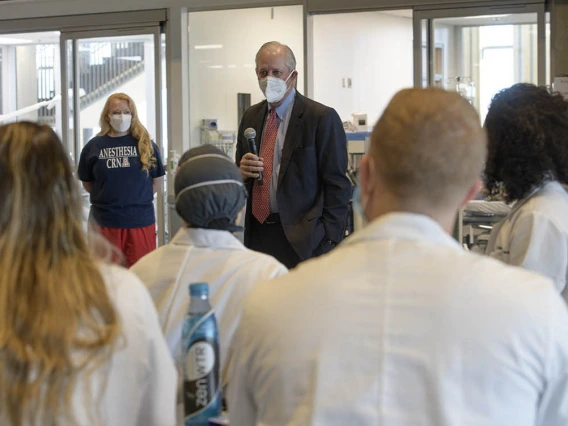 University of Arizona President Robert C. Robbins, MD, spoke to the class of second-year CRNA students and faculty during a break from their crisis management critical skills simulation. Standing next to Dr. Robbins is Kristie Hoch, DNP, CRNA, MS, RRT, Nurse Anesthesiology program administrator, who planned the crisis management scenarios that ran during the clinical skills intensive. 