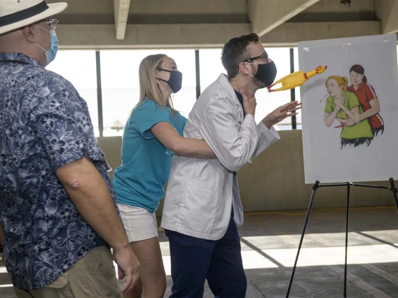 College of Medicine – Phoenix students Jennifer Codd and Erik Garber demonstrate the Heimlich maneuver, how to help someone who is choking. 