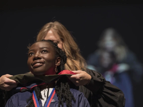 Mavis Obeng-Kusi, MSPS, is hooded by Terri Warholak, PhD, RPh, for earning her Master of Science in Pharmaceutical Sciences during the R. Ken Coit College of Pharmacy 2022 spring convocation at Centennial Hall.