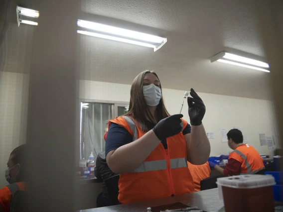 College of Pharmacy fourth-year PharmD student Annie Hiller prepares doses of the Pfizer vaccine, which will soon find their ways into the arms of recipients.