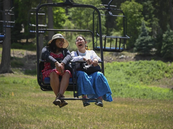 Diné College student Alyssa Joe (left) and program manager Kaitlyn Haskie enjoy a break from the heat while on a field trip to Mt. Lemmon as part of their neurosciences internship.