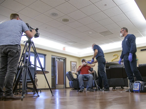 Erich Healy films the interaction of Tucson Fire Department’s Chris LaFave and Taylor Parrish with Jonathan Sexton, PhD, who is playing the role of a patient in a training video on infection control. Healy works for the Mel and Enid Zuckerman College of Public Health and the Western Regional Public Health Training Center.