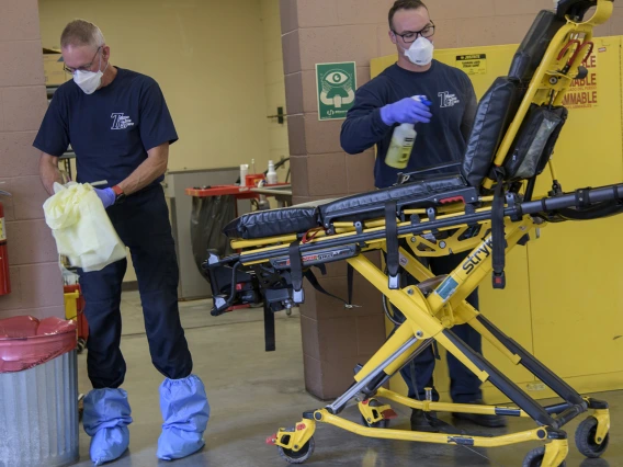 Tucson Fire Department’s Chris LaFave, left, and Taylor Parrish sanitize equipment after transporting a possible COVID-19 patient to the hospital. The University of Arizona Mel and Enid Zuckerman College of Public Health worked in conjunction with Tucson Fire Department and the Western Regional Public Health Training Center to create a training video about protocols for first responders to avoid infection during an outbreak.