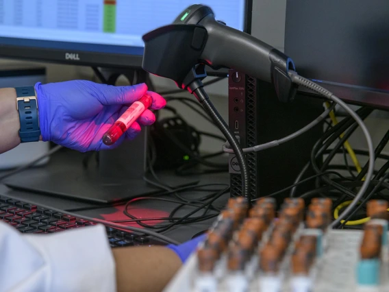 Lab technician Gina Delgado registers blood samples before they are processed to determine if they show antibodies to the virus that causes COVID-19.