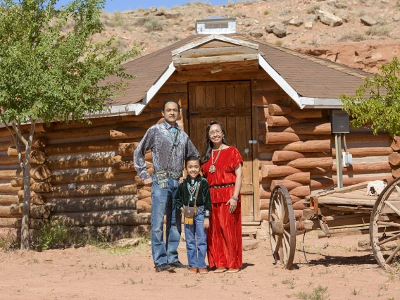 Vanessa Jensen, MD, a University of Arizona College of Medicine – Tucson surgery alumna, with her husband and son in front of their family Hogan in Tuba City, Ariz. on the Navajo Nation.