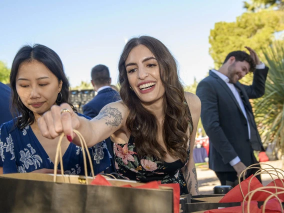 Miranda Tyree reaches for her bag that contains the letter telling her where she matched at the beginning of the UArizona College of Medicine – Tucson 2022 Match Day. 