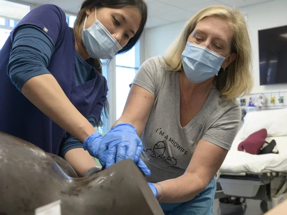 UArizona College of Nursing Doctor of Nursing Practice nurse-midwifery student learns how to guide a baby out of the birth canal.