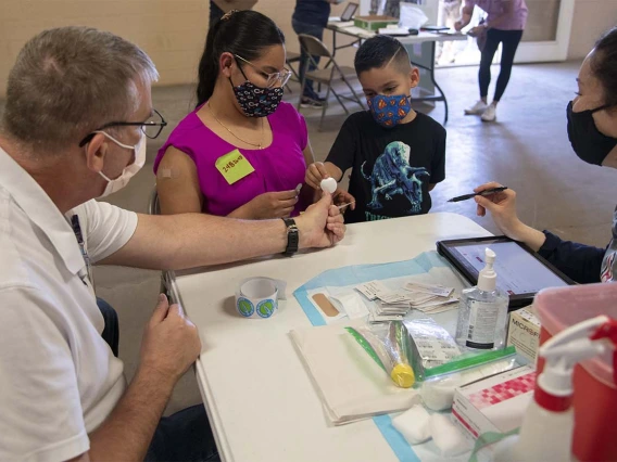 Many people brought their children with them as they visited a vaccine clinic in Aguila, Arizona, last month. Now, those children are eligible to receive the vaccine themselves.