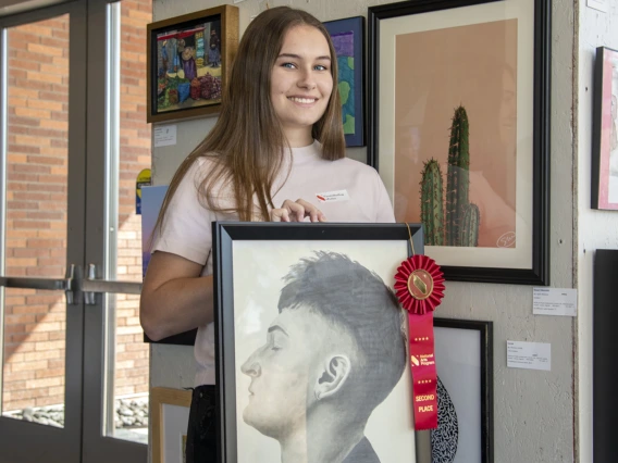 Winona Esher holds her artwork “Defined.” Esher’s UA affiliation is Melanie Esher-Blair, who works for the Department of Telemedicine.