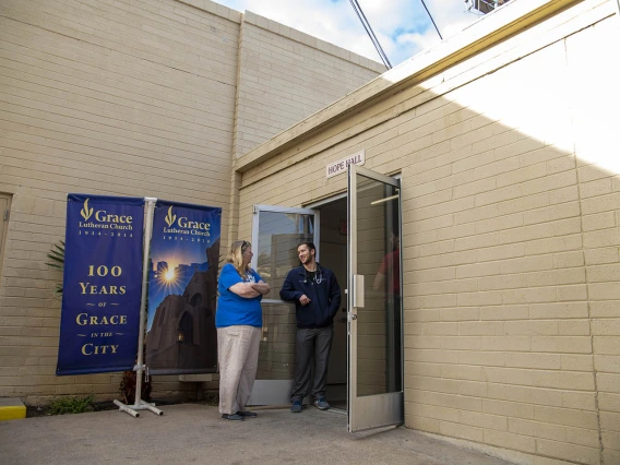 Street Medicine Phoenix co-founder Justin Zeien, right, speaks with a fellow volunteer in front of Grace Lutheran Church.