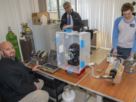 In response to the shortage of PPE, a group of researchers at the University of Arizona College of Engineering and UArizona Health Sciences worked together to design, 3D print and test masks for health care workers at Banner – University Medical Center Tucson in April. Pictured here: Lab Manager Christopher Morton, left, Sairam Parthasarathy, MD, center, and engineering graduate student Connor Stahl.