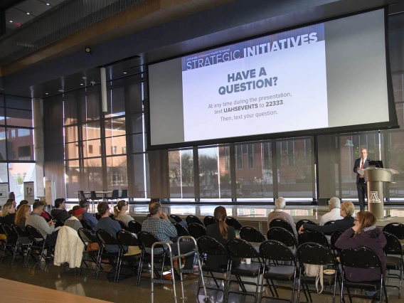 Senior Vice President for Health Sciences Michael D. Dake, MD, invites the audience and people watching the event remotely to text in questions they have for him. 