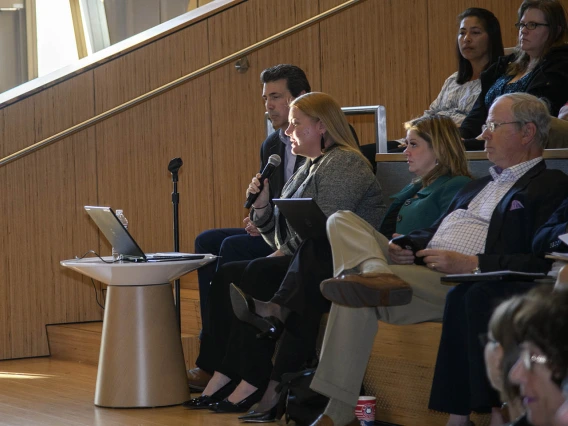 Melissa Colchado, chief of staff of management and policy at the University of Arizona Health Sciences, reads questions sent via text to Senior Vice President for Health Sciences Michael D. Dake, MD.