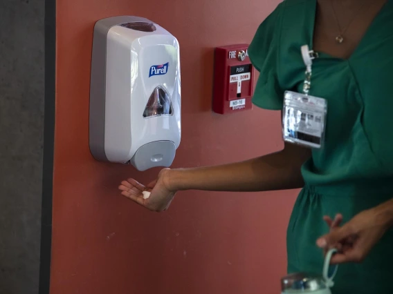 First-year College of Medicine – Tucson student Andria Albert sanitizes her hands before entering the Health Sciences Innovation Building.