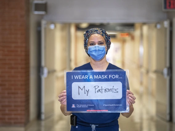 Indu Partha, MD, assistant professor at the College of Medicine – Tucson, wears a mask for her patients.