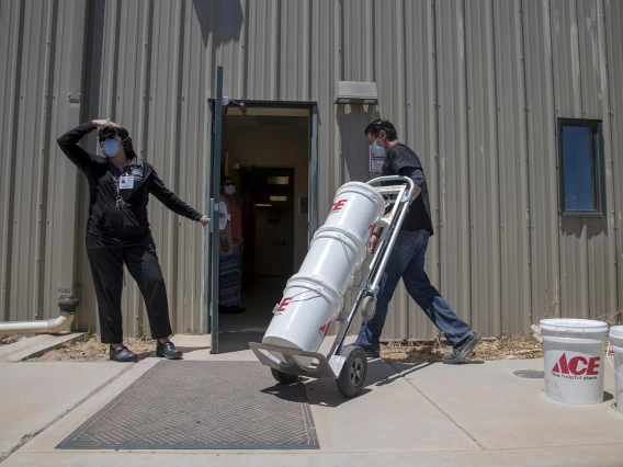 Josh Cliffords moves buckets of sanitizer into the Tuba City Regional Health Care. The sanitizer was donated by University of Arizona College of Medicine – Tucson students.