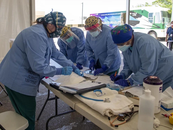 Tuba City Regional Health Care nurses and doctors working in a tent set up for COVID-19 testing.